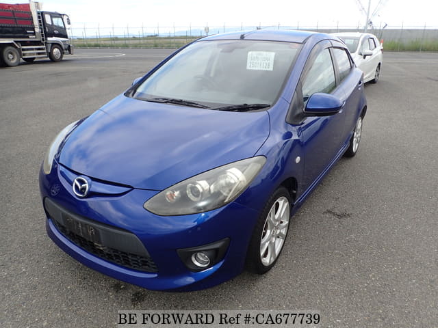 A grey JDM sports car speeding down a highway at night.