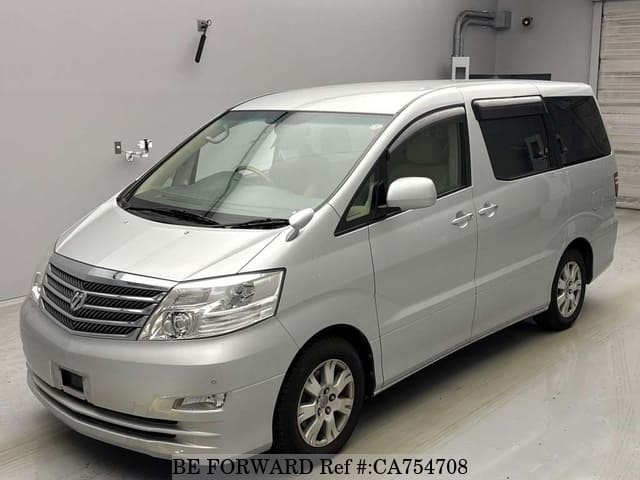 A grey JDM sports car speeding down a highway at night.