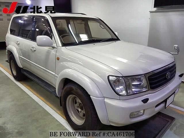 A grey JDM sports car speeding down a highway at night.