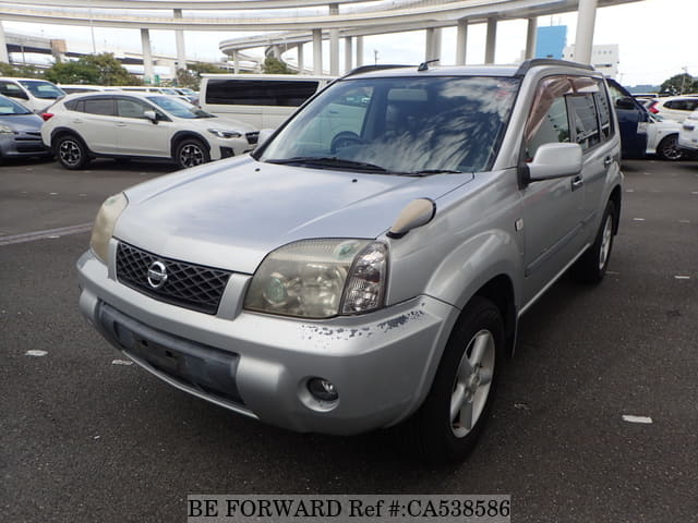A grey JDM sports car speeding down a highway at night.