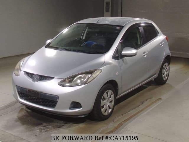 A grey JDM sports car speeding down a highway at night.