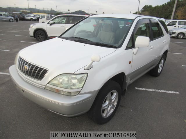 A grey JDM sports car speeding down a highway at night.