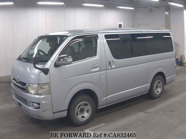 A grey JDM sports car speeding down a highway at night.