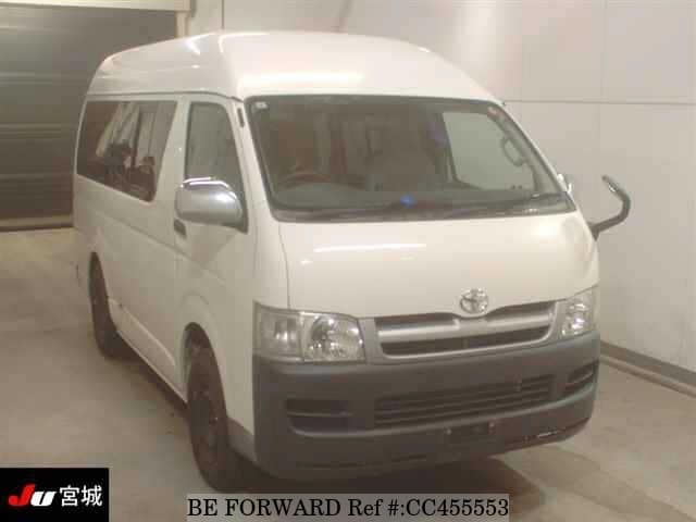 A grey JDM sports car speeding down a highway at night.