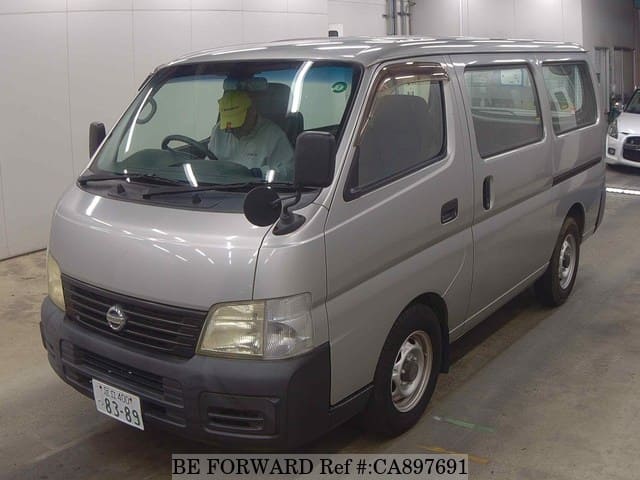 A grey JDM sports car speeding down a highway at night.