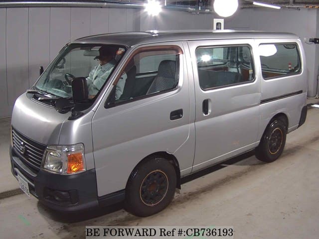 A grey JDM sports car speeding down a highway at night.