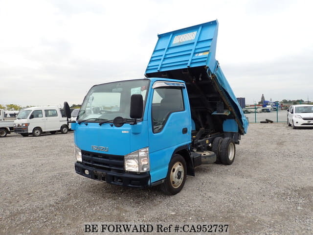 A grey JDM sports car speeding down a highway at night.