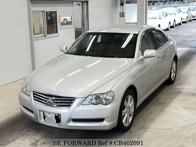 A grey JDM sports car speeding down a highway at night.