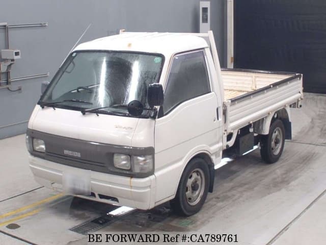 A grey JDM sports car speeding down a highway at night.