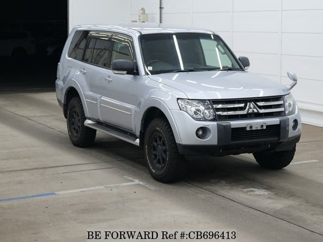 A grey JDM sports car speeding down a highway at night.