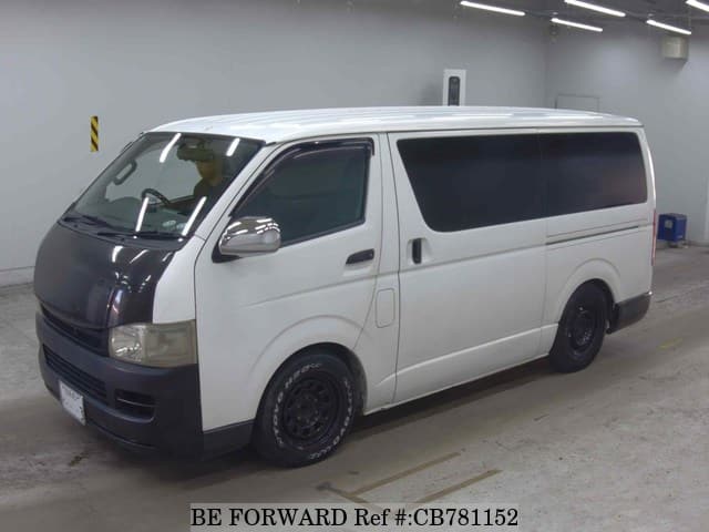 A grey JDM sports car speeding down a highway at night.
