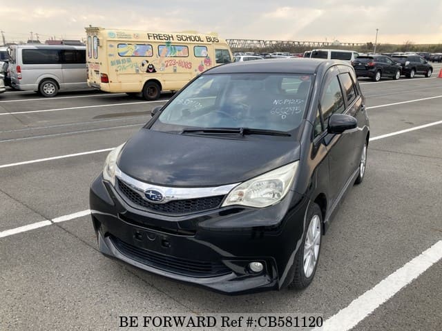 A grey JDM sports car speeding down a highway at night.