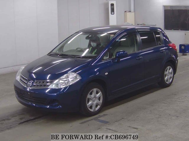 A grey JDM sports car speeding down a highway at night.