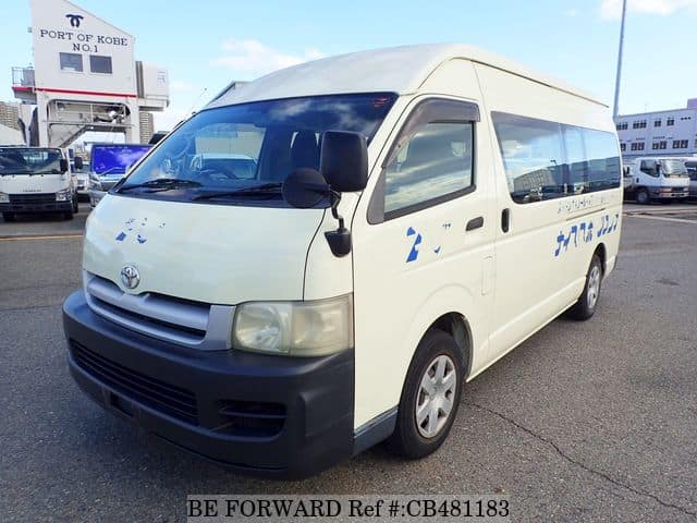 A grey JDM sports car speeding down a highway at night.