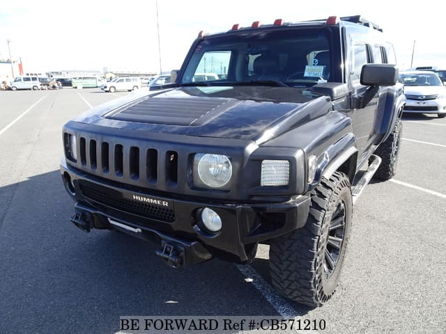 A grey JDM sports car speeding down a highway at night.