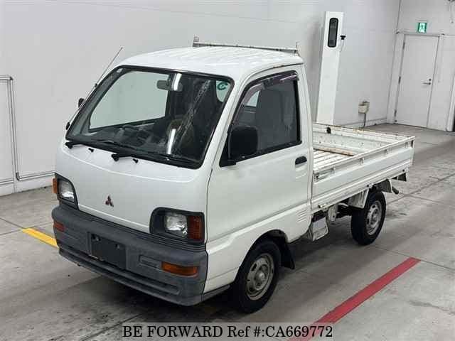 A grey JDM sports car speeding down a highway at night.