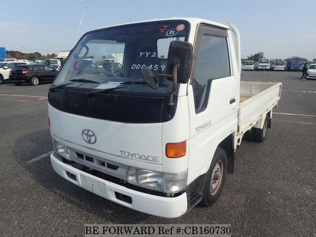 A grey JDM sports car speeding down a highway at night.