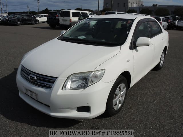 A grey JDM sports car speeding down a highway at night.