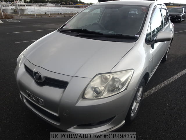 A grey JDM sports car speeding down a highway at night.