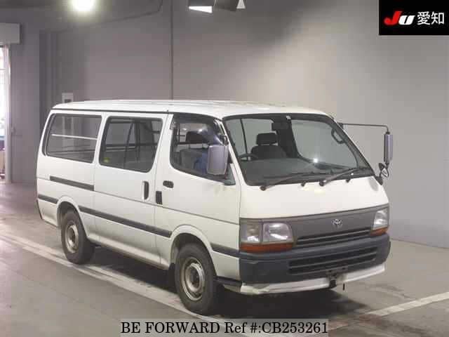A grey JDM sports car speeding down a highway at night.