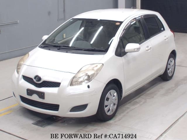 A grey JDM sports car speeding down a highway at night.