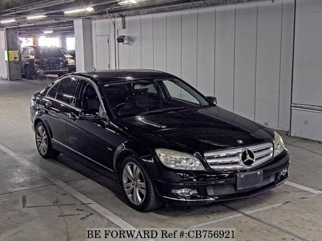 A grey JDM sports car speeding down a highway at night.