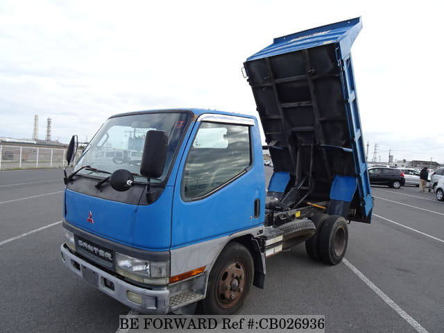 A grey JDM sports car speeding down a highway at night.