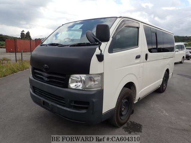 A grey JDM sports car speeding down a highway at night.