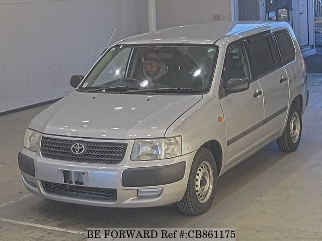 A grey JDM sports car speeding down a highway at night.