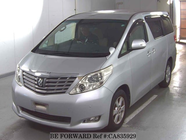 A grey JDM sports car speeding down a highway at night.