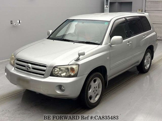 A grey JDM sports car speeding down a highway at night.