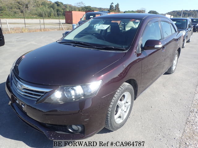 A grey JDM sports car speeding down a highway at night.