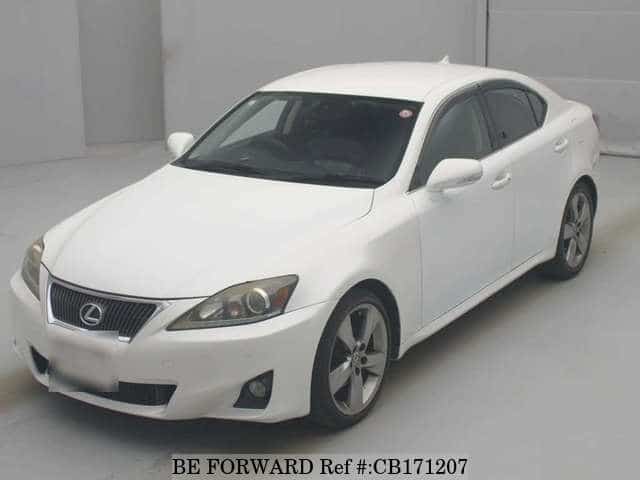 A grey JDM sports car speeding down a highway at night.