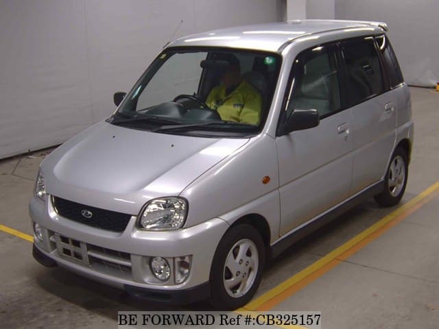 A grey JDM sports car speeding down a highway at night.