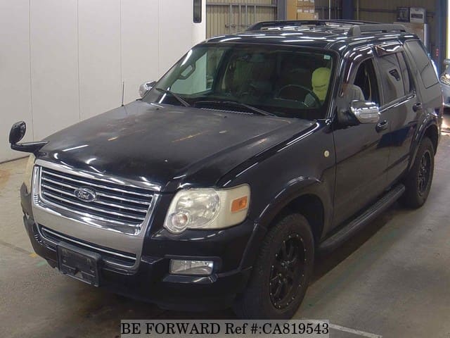 A grey JDM sports car speeding down a highway at night.