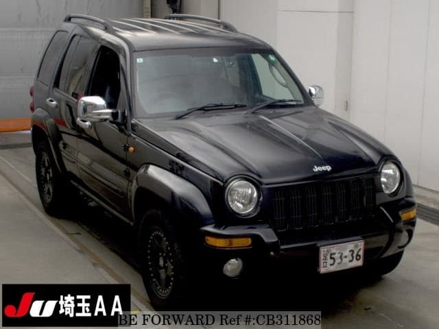 A grey JDM sports car speeding down a highway at night.