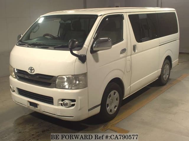 A grey JDM sports car speeding down a highway at night.
