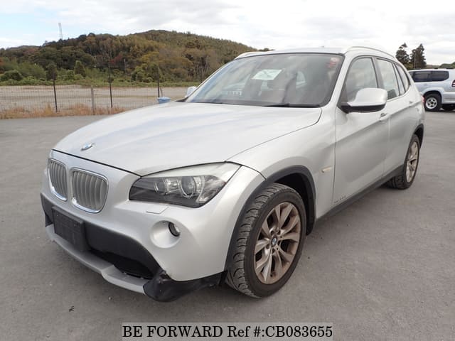 A grey JDM sports car speeding down a highway at night.