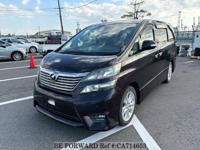 A grey JDM sports car speeding down a highway at night.