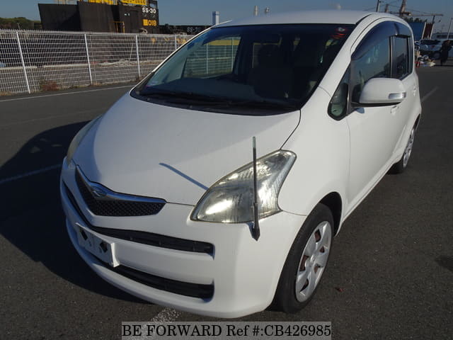A grey JDM sports car speeding down a highway at night.