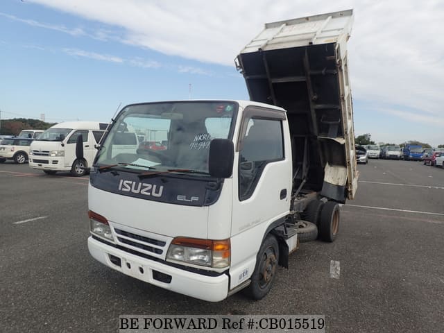 A grey JDM sports car speeding down a highway at night.