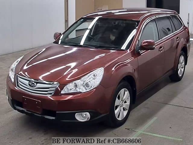 A grey JDM sports car speeding down a highway at night.
