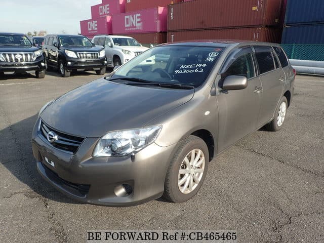 A grey JDM sports car speeding down a highway at night.