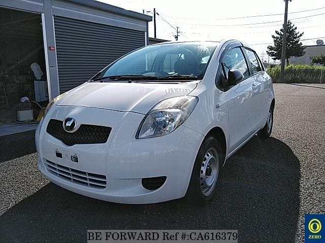 A grey JDM sports car speeding down a highway at night.