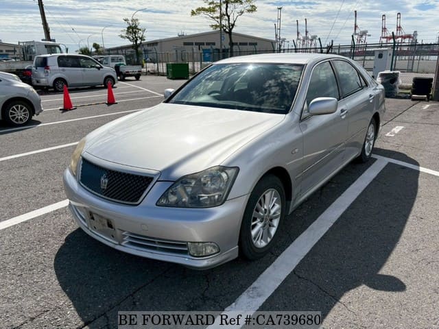 A grey JDM sports car speeding down a highway at night.