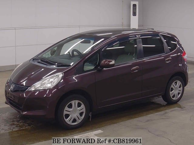 A grey JDM sports car speeding down a highway at night.