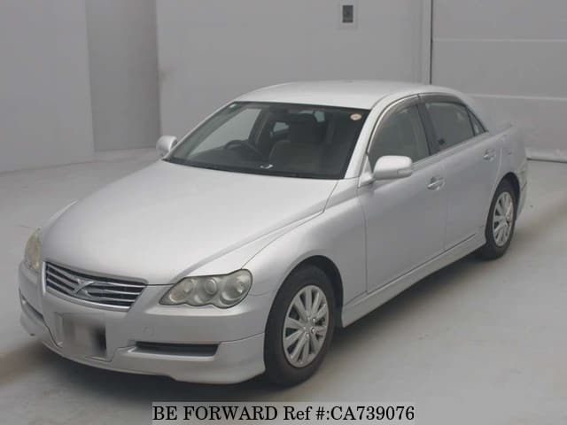 A grey JDM sports car speeding down a highway at night.