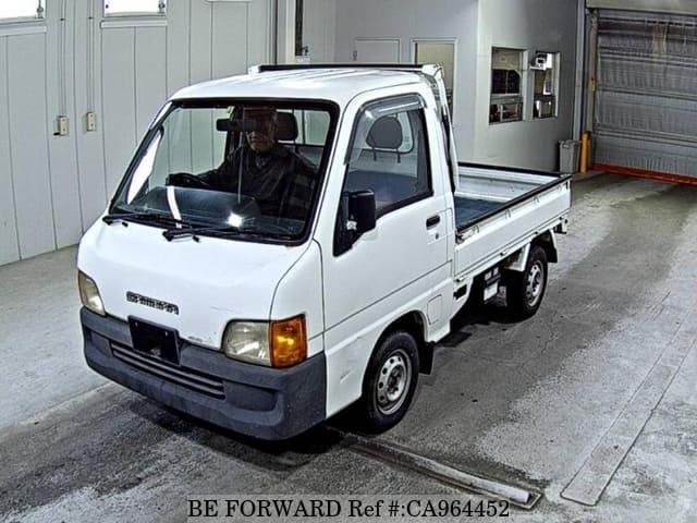 A grey JDM sports car speeding down a highway at night.