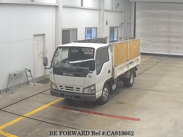 A grey JDM sports car speeding down a highway at night.