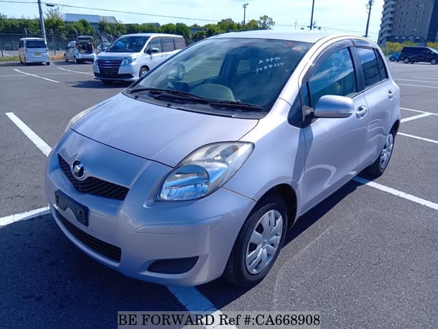 A grey JDM sports car speeding down a highway at night.